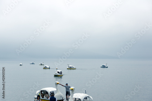 foggy lake ,swan boat
 photo