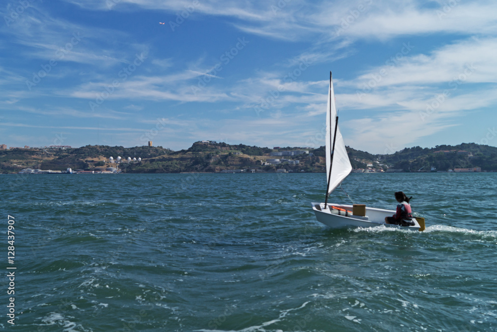 Fototapeta premium Girl with the coach involved in sailing on a sunny day