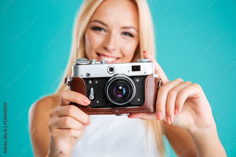 Portrait of a young attractive woman with retro camera Portrait of a young attractive woman with retro camera