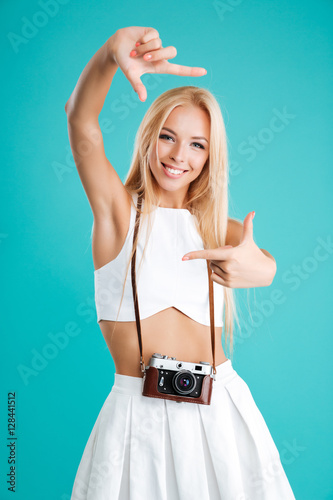 Portrait of a young attractive woman with retro camera