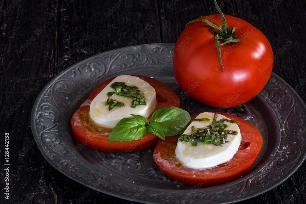 Caprese salad with mozzarella cheese, tomatoes and basil Caprese salad with mozzarella cheese, tomatoes and basil