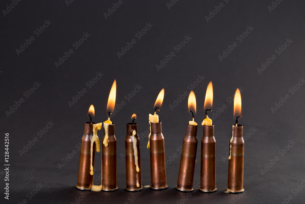 Burning candles and empty rifle cartridges. Burning candles and empty rifle cartridges.