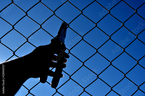 Hold nippers steel mesh sky background. photo