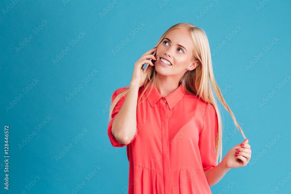 Woman talking on the phone and looking up at copyspace Woman talking on the phone and looking up at copyspace