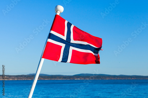 Flag of Norway over sea and blue sky