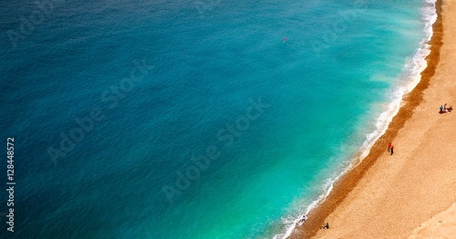 wave of blue sea on sandy beach.