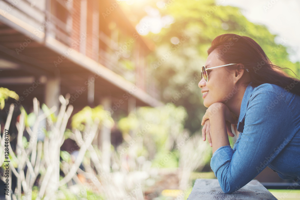 Portrait of young hipster woman relaxing on a balcony on a sunn Portrait of young hipster woman relaxing on a balcony on a sunn