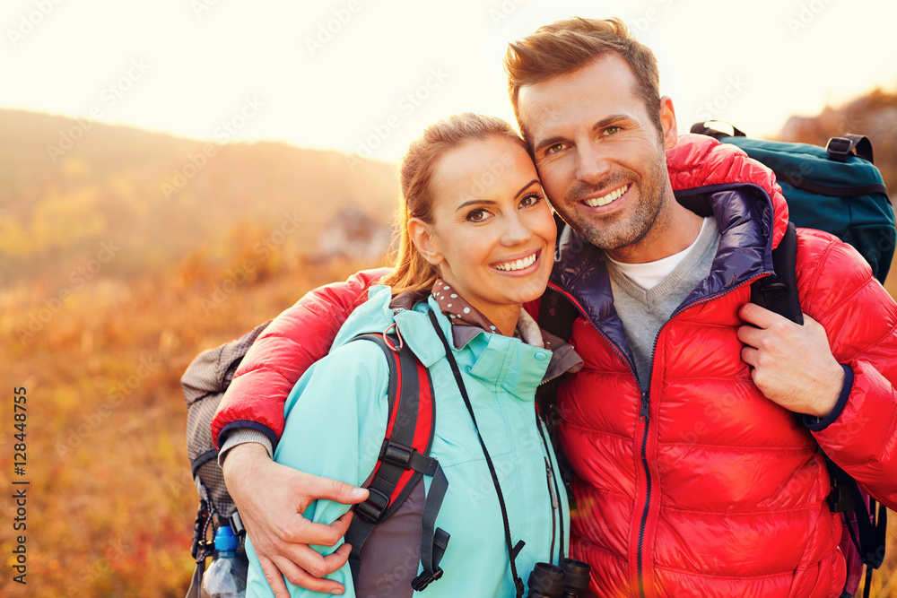 Portrait of beautiful couple hiking together during fall, autumn