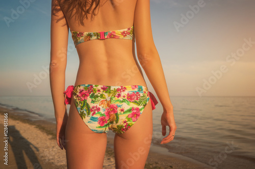 Female body on sea background. Young woman in swimsuit. Heat and beauty. It's time to get fit.