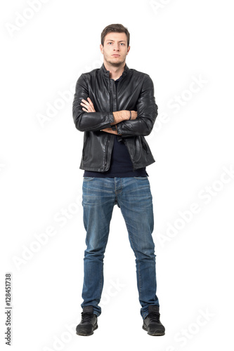 Front view of confident young man in casual clothes with crossed arms looking at camera. Full body length portrait isolated over white studio background.