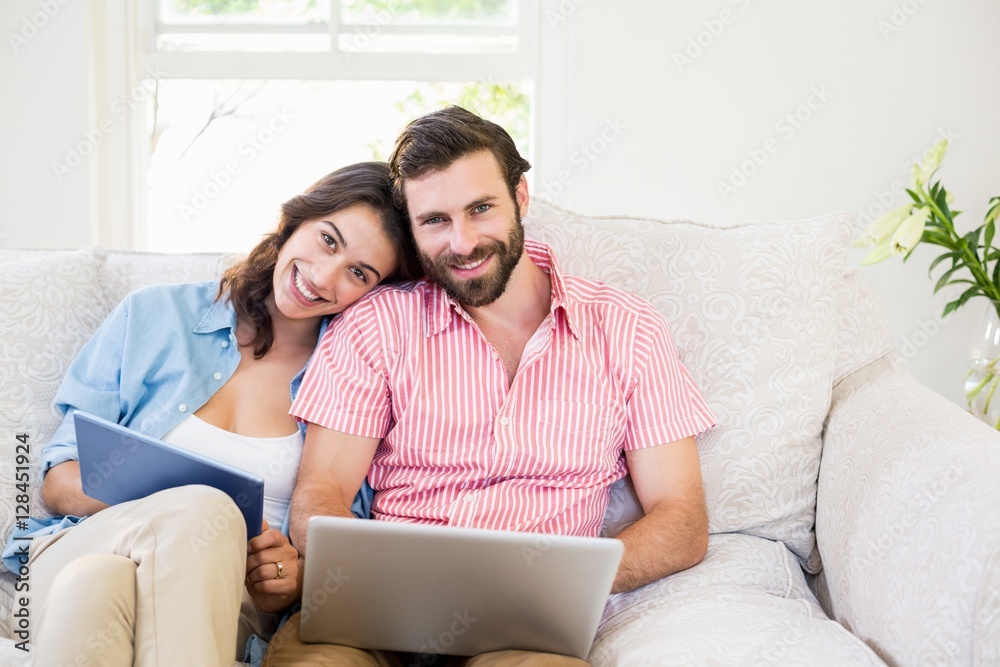 Portrait of couple using digital tablet and laptop Portrait of couple using digital tablet and laptop