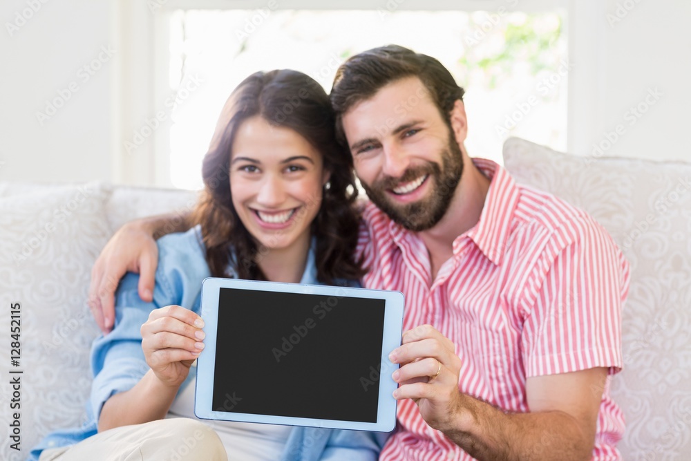 Portrait of couple showing digital tablet Portrait of couple showing digital tablet