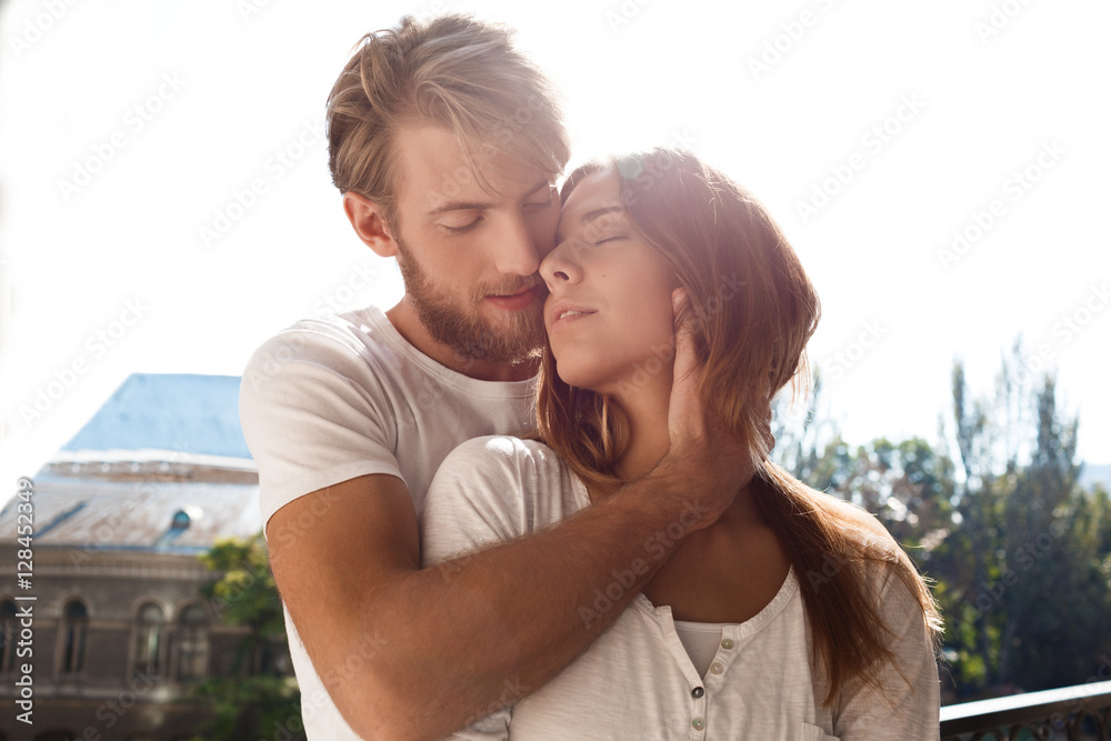 Young beautiful couple smiling enjoying standing at balcony. Young beautiful couple smiling enjoying standing at balcony.