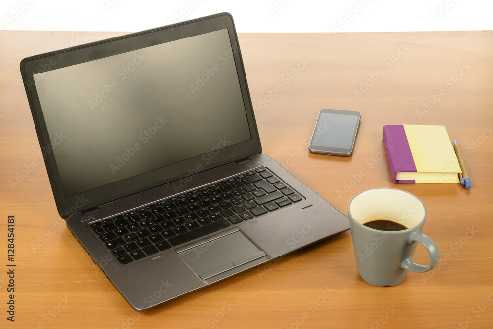 Modern Office desk with laptop, coffee, smartphone and agenda Modern Office desk with laptop, coffee, smartphone and agenda