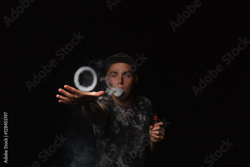 man smoking electronic cigarette lets rings of smoke