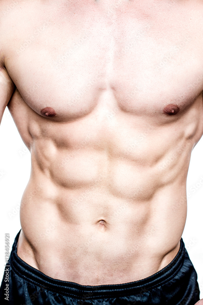 handsome young strong man posing in studio