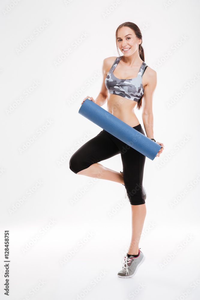 Full length of happy fitness woman with mat Full length of happy fitness woman with mat