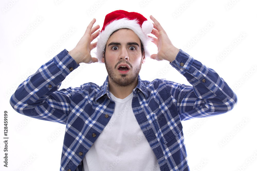 young man with a santa claus hat and face of a scare young man with a santa claus hat and face of a scare