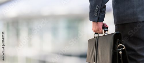 Detail of a businessman holding a leather briefcase photo
