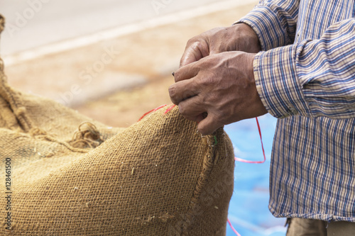 Farmer and paddy rice seed in a Burlap sack