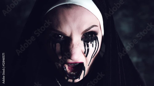 4k Halloween Shot of a Horror Woman Screaming with Blackout Eyes photo