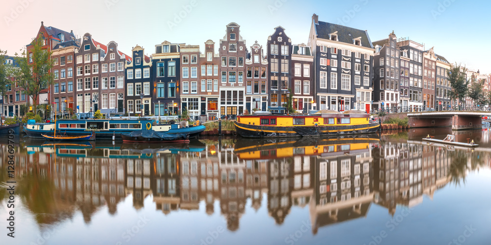 Fototapeta premium Panorama of Amsterdam canal Singel with typical dutch houses, bridge and houseboats during morning blue hour, Holland, Netherlands.