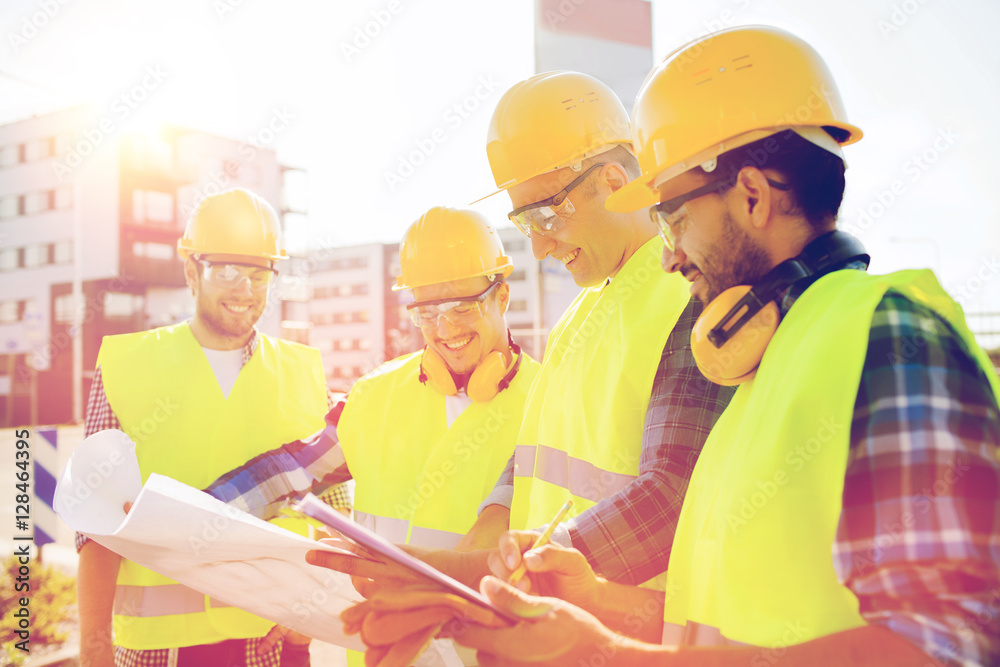 group of builders with tablet pc and blueprint group of builders with tablet pc and blueprint