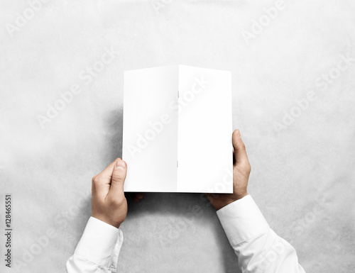 Hand holding blank white brochure mockup, back side view. Booklet cover presentation. Leaflet turnover mock up.