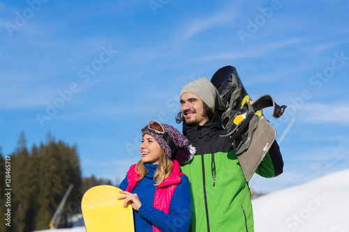 Couple With Snowboard And Ski Resort Snow Winter Mountain Smiling Man And Woman Extreme Sport Vacation