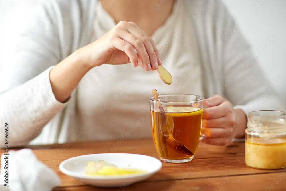 close up of ill woman drinking tea with ginger close up of ill woman drinking tea with ginger
