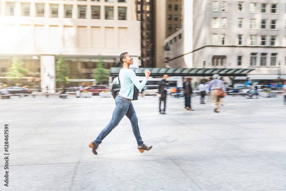 Panning view of a woman running in the city