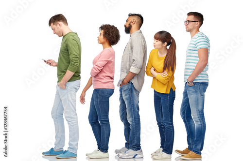 group of people in queue with smartphone