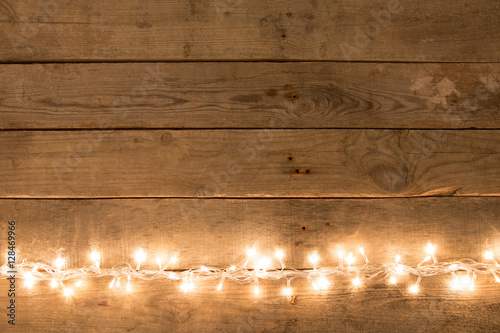 Christmas rustic background - vintage planked wood with lights and free text space