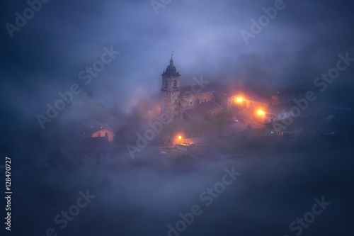 church under fog at night in Aramaio