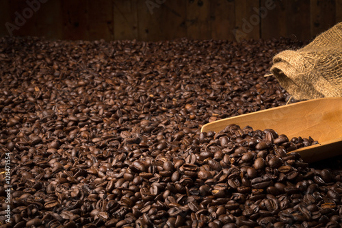 Coffee with serving spoon on a wooden table completely covered photo