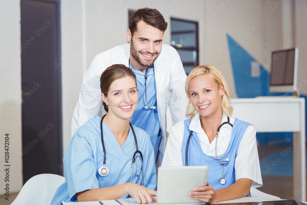 Portrait of cheerful doctor colleagues with digital tablet 