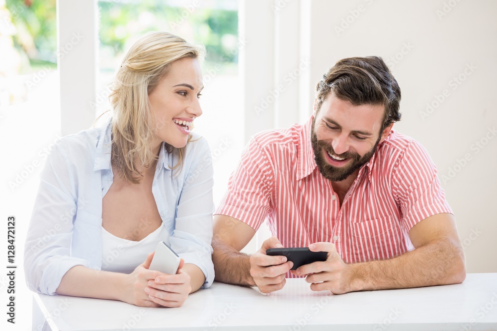 Smiling couple using a mobile phone Smiling couple using a mobile phone