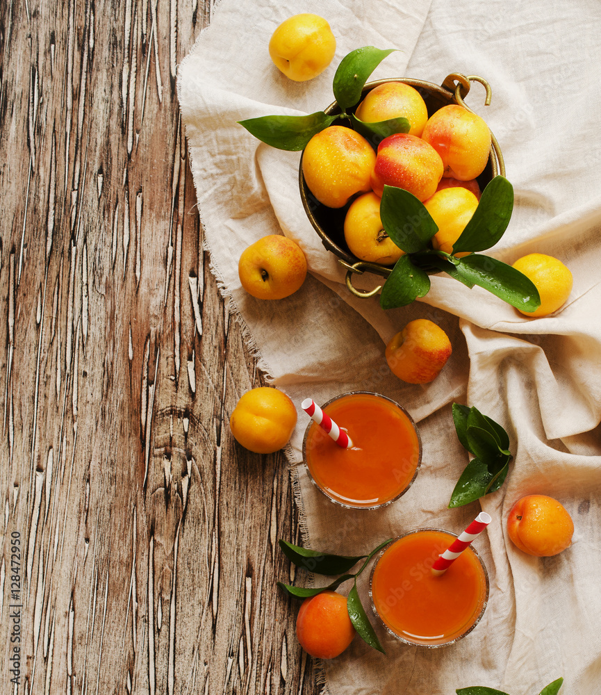 Fresh apricot juice in glass on wooden table, selective focus Fresh apricot juice in glass on wooden table, selective focus