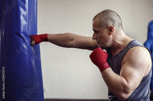 strong man doing workout in the boxing hall
