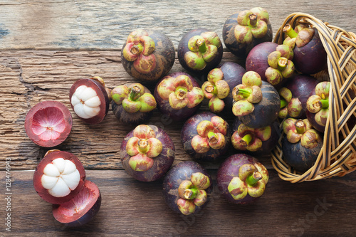 Mangosteen fruit on wood table with top view photo