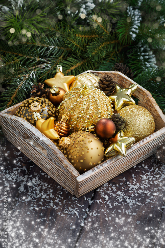 wooden tray with golden Christmas decorations on table