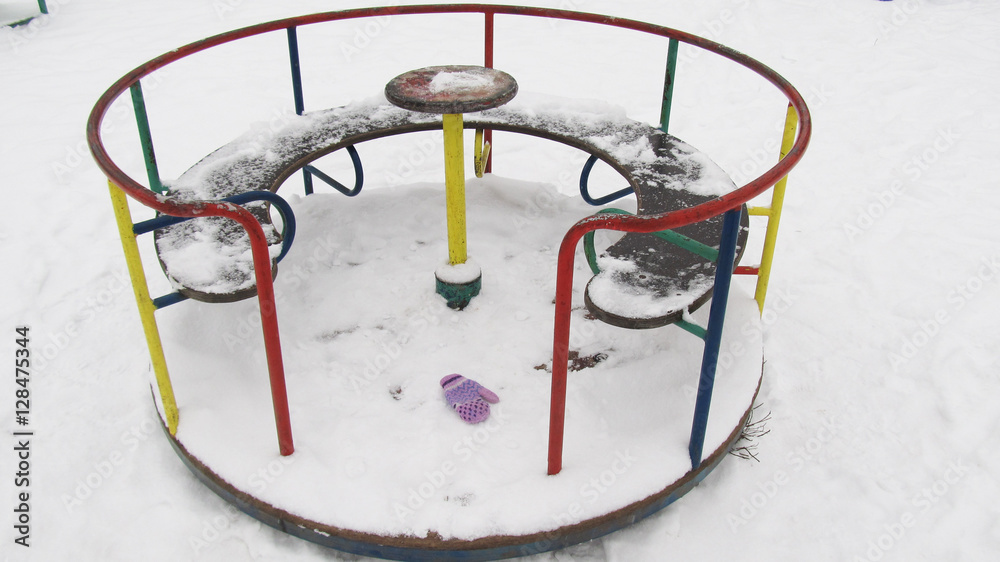 Lonely children's carousel in winter, forgotten mitten in the snow
Lonely children's carousel in winter, forgotten mitten in the snow
