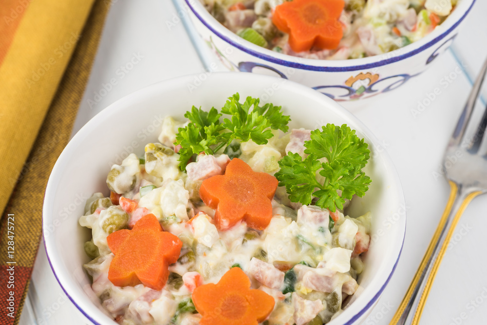 Traditional russian olivier salad with ham vegetables. Traditional russian olivier salad with ham vegetables.
