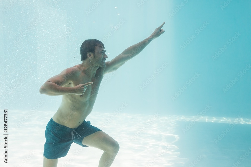 Man gesturing while standing underwater Man gesturing while standing underwater