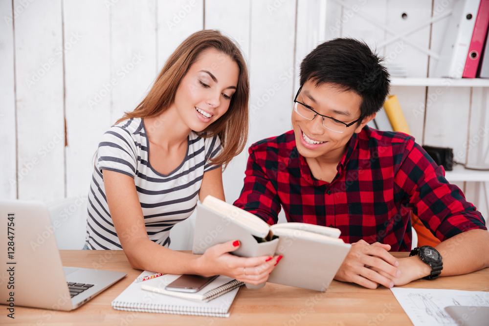 Happy students learning education material with book Happy students learning education material with book