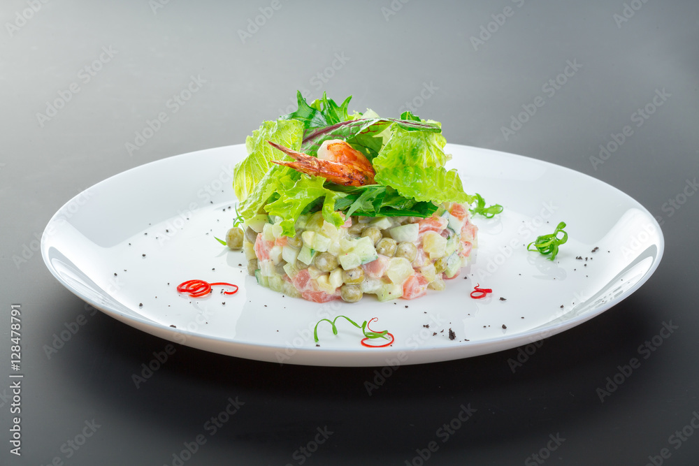 Olivier salad with chicken in a white plate Olivier salad with chicken in a white plate