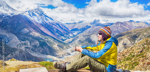Hiker drinking tea in Himalayas mountains. Banner.