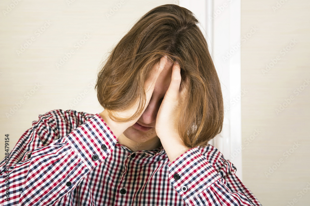 Guy with long hair hides the face in hands. Grieves concept Guy with long hair hides the face in hands. Grieves concept