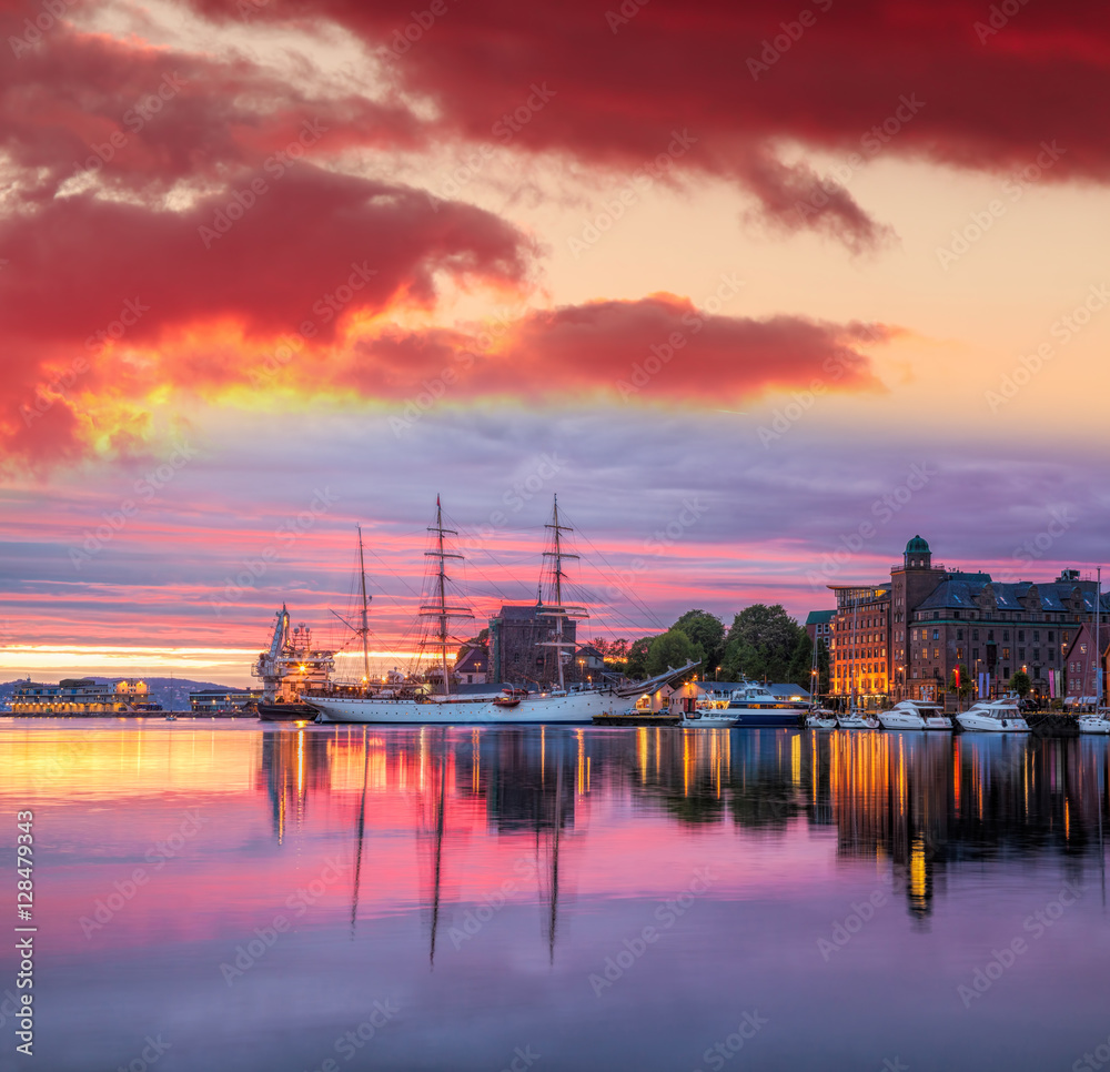 Bergen harbor with boats against colorful sunset in Norway, UNESCO World Heritage Site