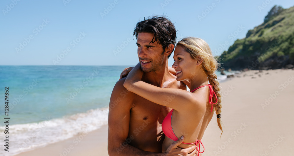 Affectionate young couple embracing on the beach Affectionate young couple embracing on the beach